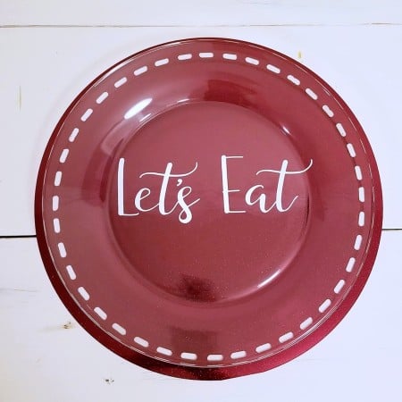 Red dinner plate decorated with the words Let's Eat on it