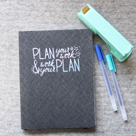 Gray planner with the words Plan Your Work and Word Your Plan