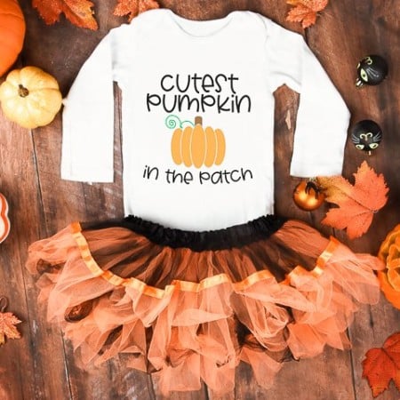 White long sleeved shirt with an image of a pumpkin on it and the words, Cutest Pumpkin in the Patch