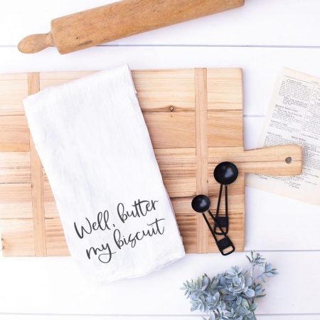 White kitchen towel that says Well, Butter My Biscuit