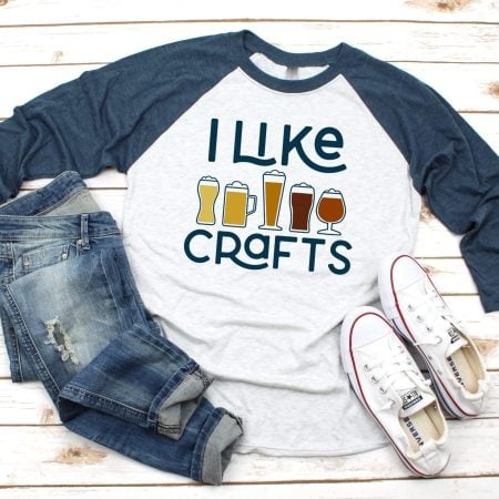 Baseball style t-shirt with images of glasses of beer on it and the saying I Like Crafts
