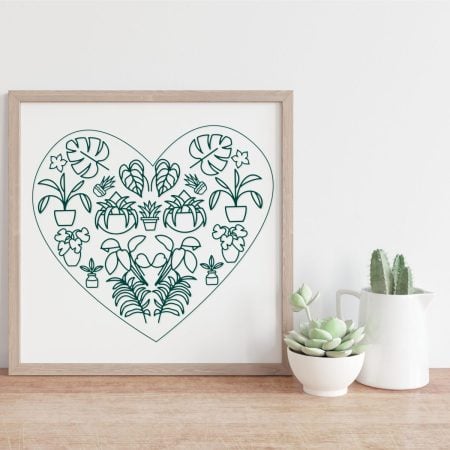 A heart made with different plants in a framed picture
