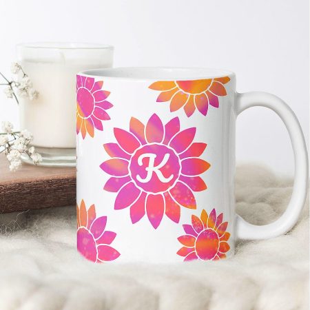 White mug deocrated with a sunflower monogram