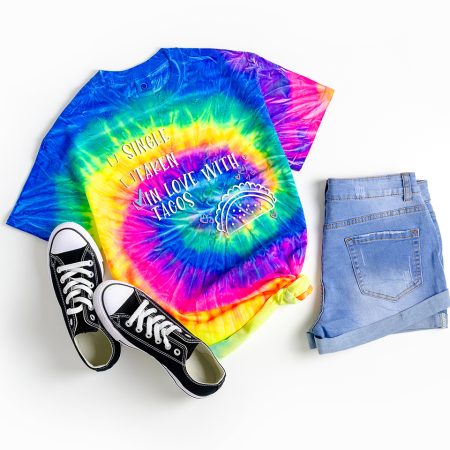 Bright tie dyed t-shirt that says SINGLE, TAKEN, IN LOVE WITH TACOS