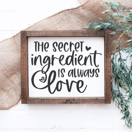 Image in a wooden frame with saying The Secret Ingredient is Always Love