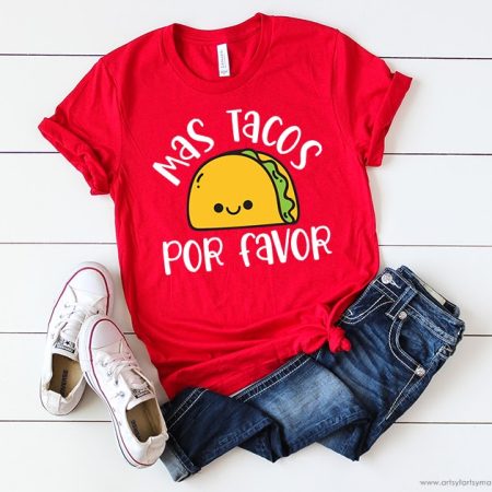 Red t-shirt with an image of a taco on it and the saying Mas Tacos Por Favor