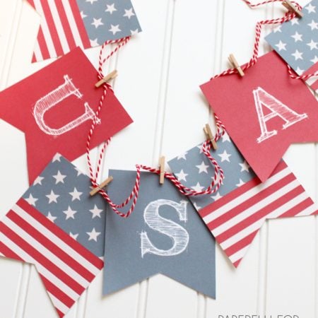A paper USA banner in red white and blue printed on cardstock
