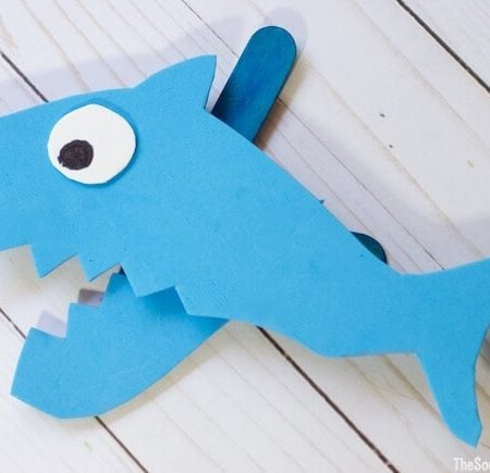 A blue shark puppet made out of foam