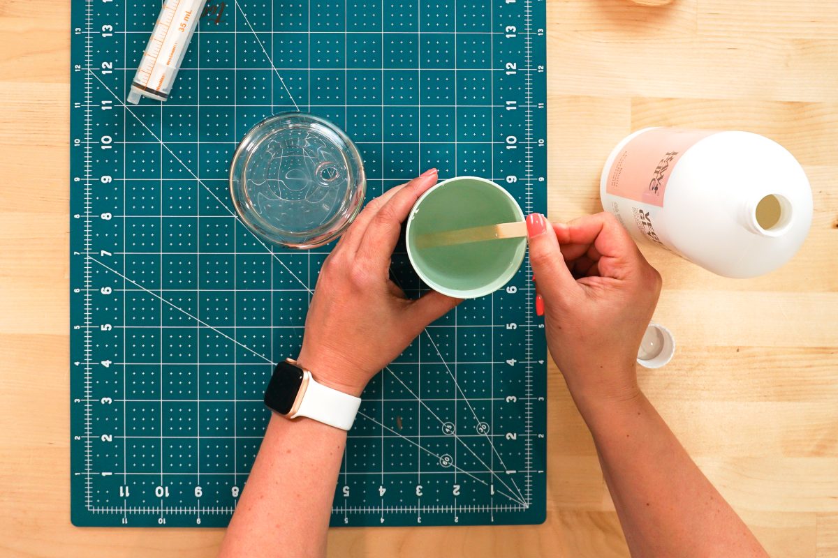 Overhead shot of hands mixing the water and glycerine solution