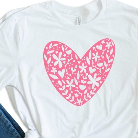 White t-shirt with a pink heart filled with doodles
