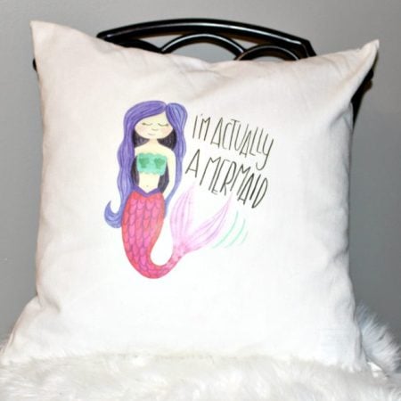 Pillow with a mermaid on it saying I am Actually a Mermaid