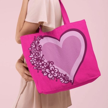 A woman carrying a pink tote bag decorated with hearts