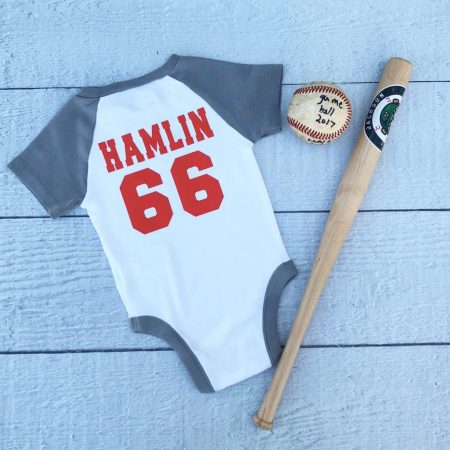Baby onesie with the child's name on it and the number 66