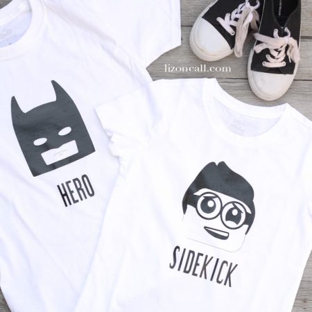 Two white t-shirts with images of Batman and Robin