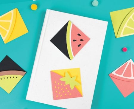 A book with paper bookmarks made out of fruit designs