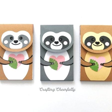 Image of three paper notepads decorated with sloths