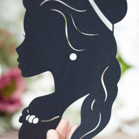 A woman's hand holding a Disney Princess Silhouette