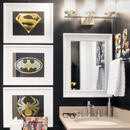Sophisticated super hero framed art hanging in a bathroom