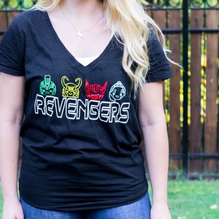 A woman wearing a black t-shirt with the word Revengers and characters from the Thor Ragnarok movie
