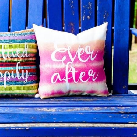 Two bright colored pillows, one saying Live Happily and the other days Ever After