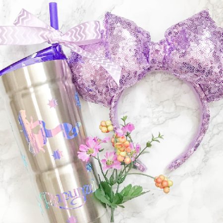 A stainless steel travel cup decorated with a Rapunzel design
