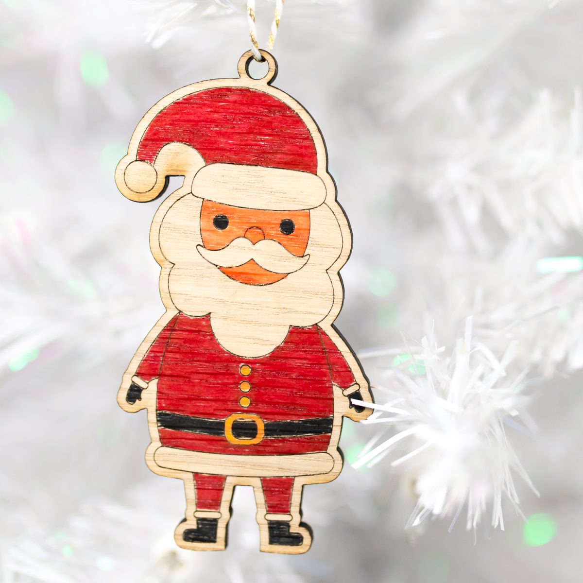 colored santa ornament on white tree