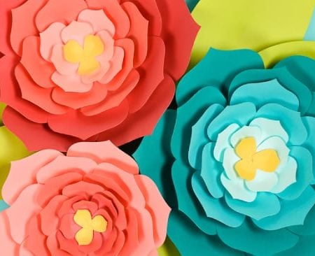 Giant paper flowers in teal, coral and pink colors