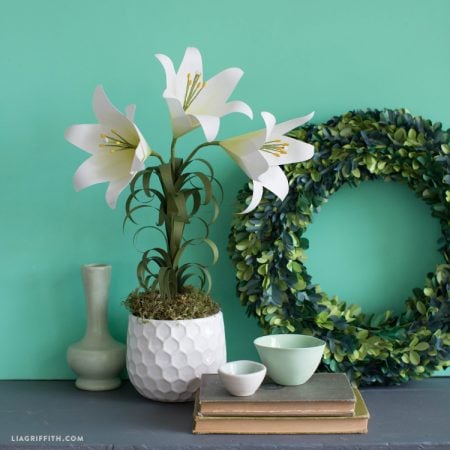 White vase with three paper Easter lilies