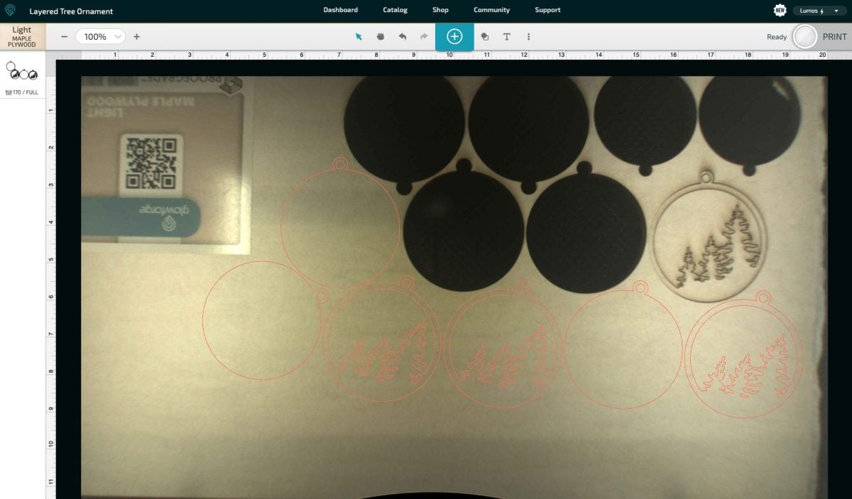 Glowforge App with ornaments laid out on wood.