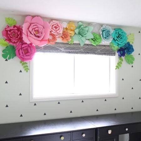 Colorful paper flowers above window