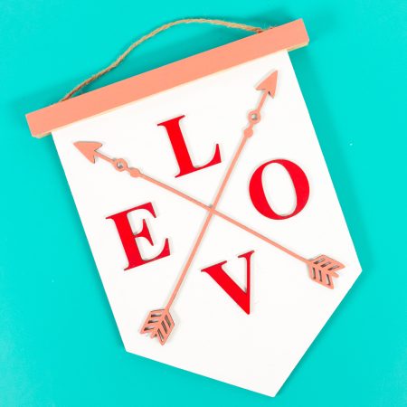 Finished LOVE sign on a teal background