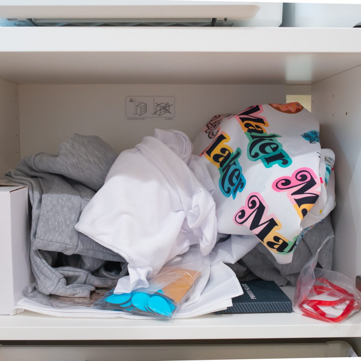 Closeup of messy cabinet full of unorganized sublimation supplies