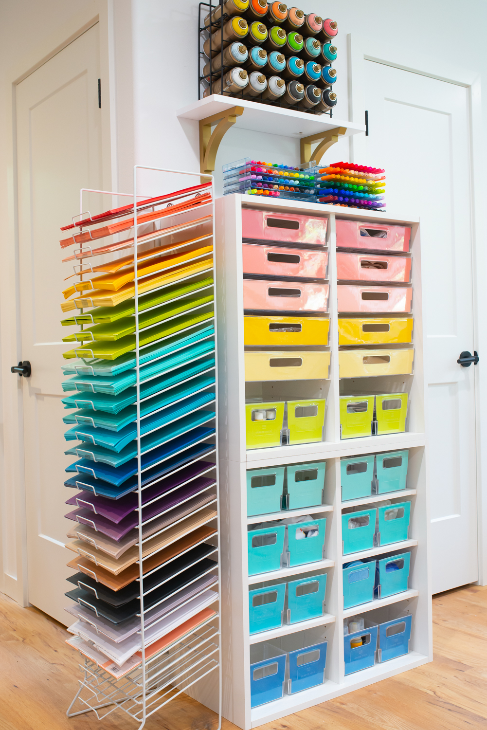 Side view of two Create Room Cubbies stacked on top of each other with drawer fronts organized in rainbow order filled with supplies.