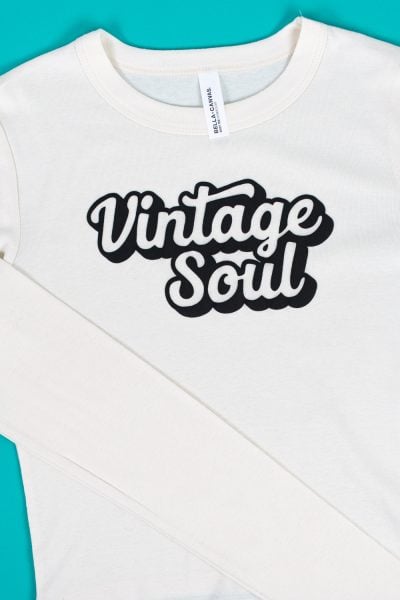 Vintage Soul SVG made with Puff HTV on a cream-colored baby tee on a teal background