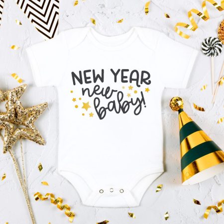 New Year's Eve props next to a white baby onesies that says, New Year, New Baby!
