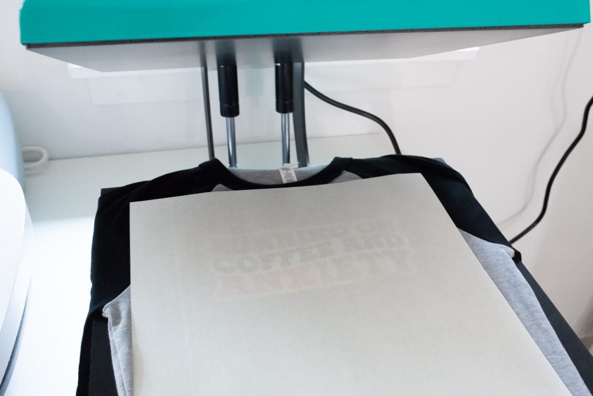 Heat Press with SubliFlock on top of a t-shirt with butcher paper.