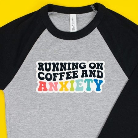 "Running on Coffee and Anxiety" image on SubliFlock on gray and black baby tee