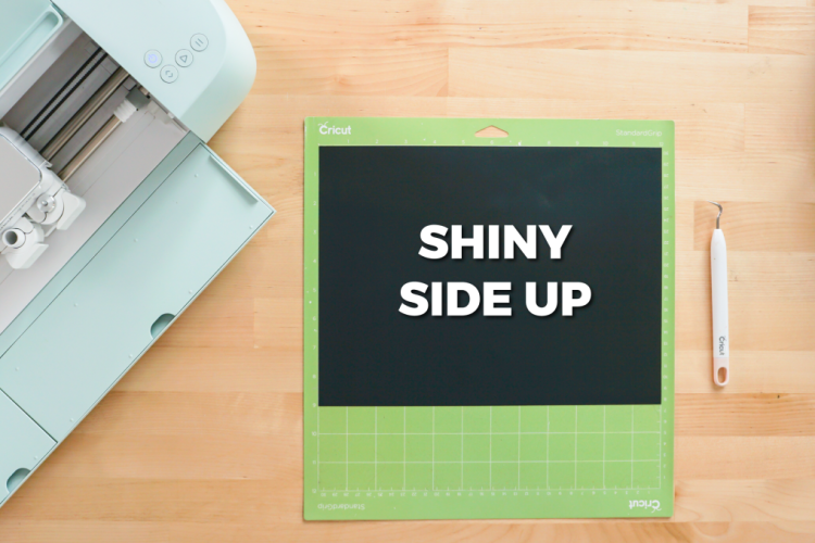 Black Puff HTV on cutting mat with "shiny side up" written on it