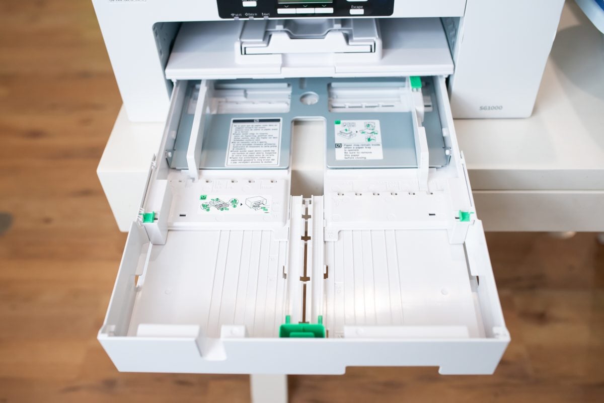 Sawgrass SG1000 printer with open paper tray showing tray extended to max size.