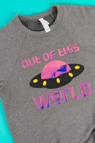 Gray Bella+Canvas sponge fleece sweatshirt with holographic "out of this world" image