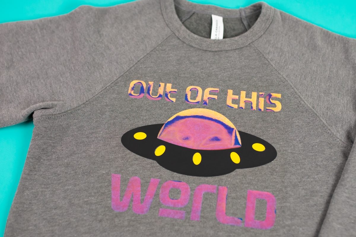 Gray Bella+Canvas sponge fleece sweatshirt with holographic "out of this world" image