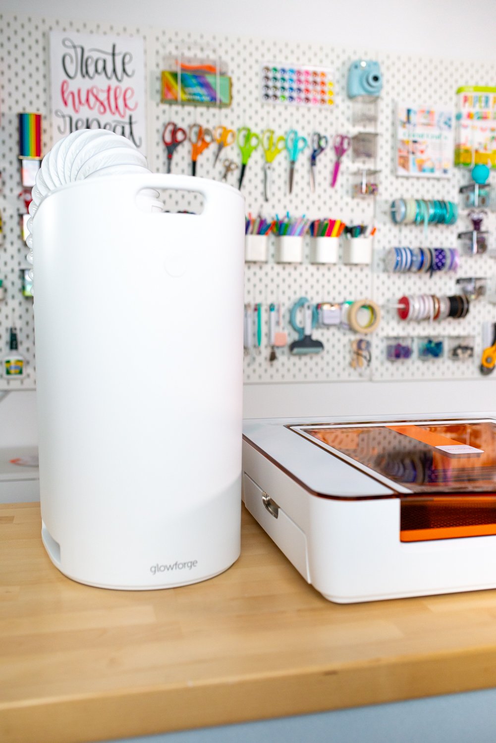 Glowforge Aura personal filter on desk next to Aura.