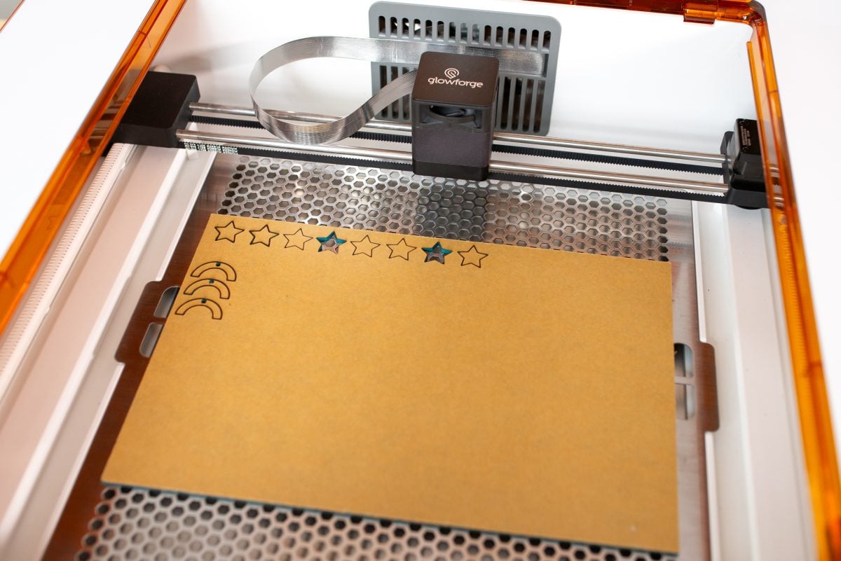 Glowforge Aura with non-proofgrade materials in bed.