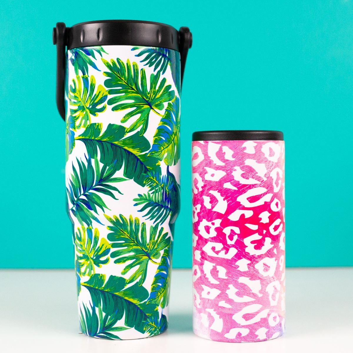 Final leaf and leopard sublimation tumblers on teal background