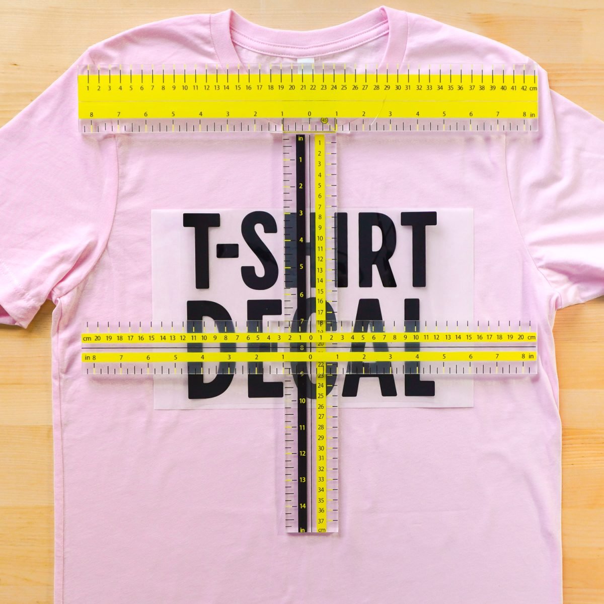 Pink t-shirt with decal and UPTTHOW ruler