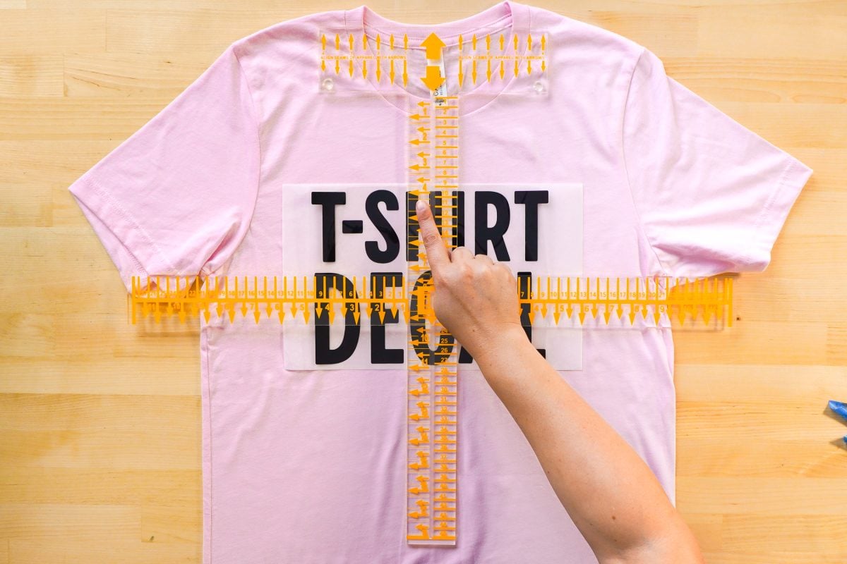 Hands showing decal placement on Tee Square It ruler