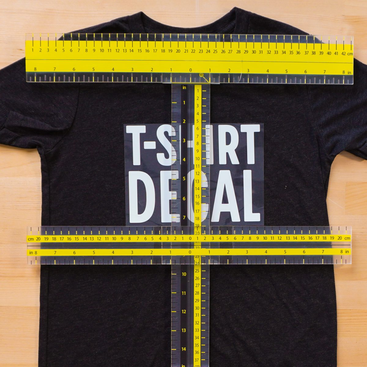 Black kid's tee with UPTTHOW ruler