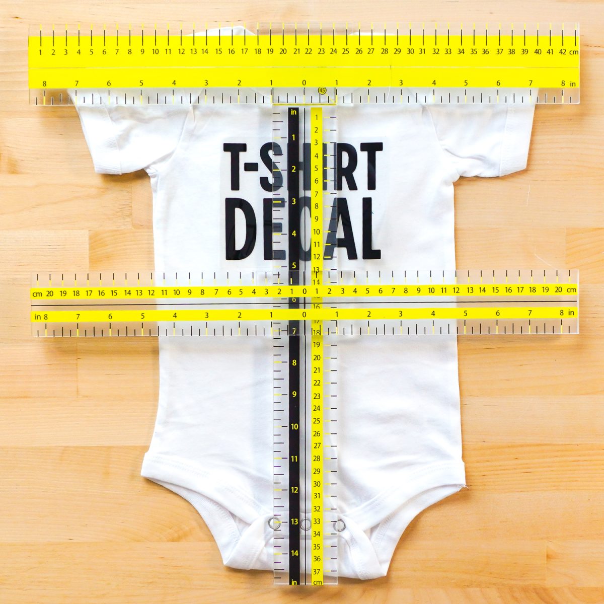 Onesie with UPTTHOW ruler