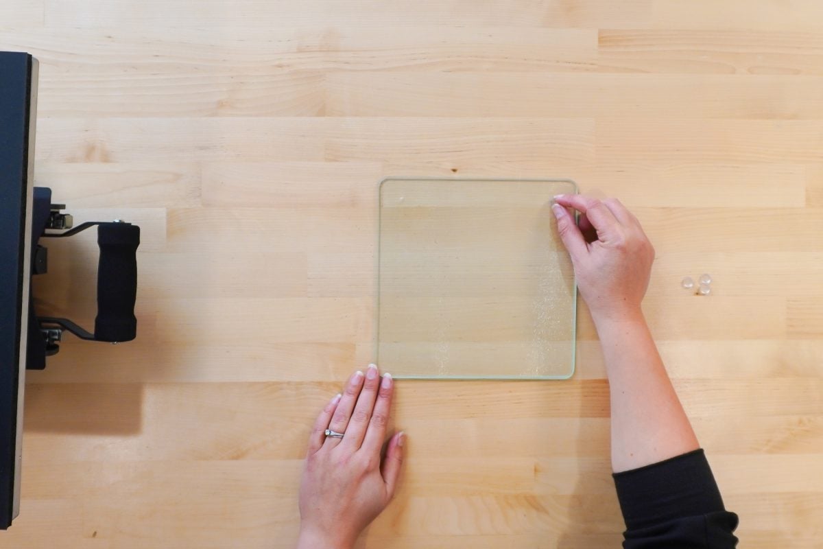 Hand removing feet from glass cutting board