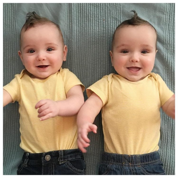 Twin baby boys in yellow shirts